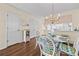 Dining area with wood floors adjacent to the kitchen with a glass table and wicker chairs at 613 S 2Nd Ave. # 21D, North Myrtle Beach, SC 29582