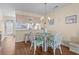 Cozy dining area with a glass table and white wicker chairs near the kitchen at 613 S 2Nd Ave. # 21D, North Myrtle Beach, SC 29582