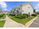 A view of the exterior of the building shows meticulous landscaping and manicured lawns at 613 S 2Nd Ave. # 21D, North Myrtle Beach, SC 29582