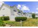 Exterior view of townhomes featuring a white fence and green landscaping at 613 S 2Nd Ave. # 21D, North Myrtle Beach, SC 29582
