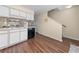 Eat in kitchen featuring sleek black dishwasher, white cabinets and wood flooring at 613 S 2Nd Ave. # 21D, North Myrtle Beach, SC 29582