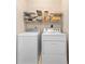 Functional laundry room with washing machine, dryer and shelving at 613 S 2Nd Ave. # 21D, North Myrtle Beach, SC 29582