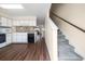 Open concept kitchen and carpeted staircase at 613 S 2Nd Ave. # 21D, North Myrtle Beach, SC 29582