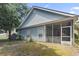 Backyard view of a screened-in porch with outdoor space and siding at 618 5Th Ave. S, North Myrtle Beach, SC 29582