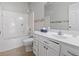 Bright bathroom featuring a tub-shower combo and single sink vanity with floral wallpaper accents at 618 5Th Ave. S, North Myrtle Beach, SC 29582