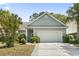 Inviting one-story home featuring a spacious garage and mature landscaping at 618 5Th Ave. S, North Myrtle Beach, SC 29582