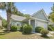 Charming single-story home with well-manicured landscaping and a garage at 618 5Th Ave. S, North Myrtle Beach, SC 29582