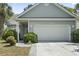 Charming home featuring a spacious garage and well-manicured front bushes at 618 5Th Ave. S, North Myrtle Beach, SC 29582