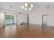 Open living room with vaulted ceiling, hardwood floors, and sliding door access to porch at 618 5Th Ave. S, North Myrtle Beach, SC 29582
