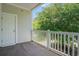Apartment balcony featuring white railing with scenic views of mature trees and landscaping at 6253 Catalina Dr. # 1523, North Myrtle Beach, SC 29582