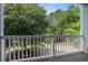 Private balcony boasting white railing and a scenic view of lush trees and landscaping at 6253 Catalina Dr. # 1523, North Myrtle Beach, SC 29582