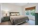Comfortable bedroom with green headboard and scenic view at 6253 Catalina Dr. # 1523, North Myrtle Beach, SC 29582