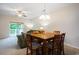 Dining room with wooden table and chairs next to the living room and sliding doors to balcony at 6253 Catalina Dr. # 1523, North Myrtle Beach, SC 29582