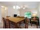 Dining room with wooden table, chairs and carpet next to the living room at 6253 Catalina Dr. # 1523, North Myrtle Beach, SC 29582