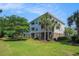 Exterior view of a multi-story apartment building with private balconies and lush greenery at 6253 Catalina Dr. # 1523, North Myrtle Beach, SC 29582