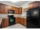 Charming kitchen equipped with wooden cabinets and black appliances at 6253 Catalina Dr. # 1523, North Myrtle Beach, SC 29582