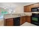 Cozy kitchen featuring wood cabinets and black appliances at 6253 Catalina Dr. # 1523, North Myrtle Beach, SC 29582
