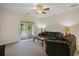 Living room with couches, coffee table, ceiling fan and slider doors leading to balcony at 6253 Catalina Dr. # 1523, North Myrtle Beach, SC 29582