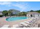 Community pool with clear blue water, surrounded by lounge chairs and lush landscaping for relaxation at 6253 Catalina Dr. # 1523, North Myrtle Beach, SC 29582