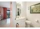 Cozy bathroom featuring a white vanity, toilet, and an adjacent closet and door to the patio at 6813 Porcher Dr. # 1, Myrtle Beach, SC 29572