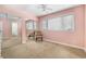 Bedroom with a pink accent wall, mirrored closet, and natural light from the window at 6813 Porcher Dr. # 1, Myrtle Beach, SC 29572