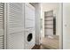 Convenient laundry room with a stacked washer and dryer and a shelving unit at 6813 Porcher Dr. # 1, Myrtle Beach, SC 29572