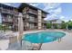 Exterior shot of community pool with lounge chairs and tables for relaxing at 6813 Porcher Dr. # 1, Myrtle Beach, SC 29572