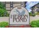 Community sign, 'Heron Pond', set among lush greenery at 6813 Porcher Dr. # 1, Myrtle Beach, SC 29572