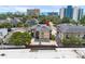 Aerial view of a multi-story condo complex surrounded by trees, buildings, and a beach backdrop at 6813 Porcher Dr. # 25, Myrtle Beach, SC 29572