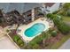 Aerial view of condominium building and community pool and lounge area surrounded by greenery at 6813 Porcher Dr. # 25, Myrtle Beach, SC 29572