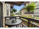 Balcony view with a table and hanging plants of a condo building on a sunny day at 6813 Porcher Dr. # 25, Myrtle Beach, SC 29572