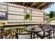 Outdoor balcony seating area, with a small round table, chairs, and green plant on the side at 6813 Porcher Dr. # 25, Myrtle Beach, SC 29572