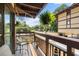 View from a cozy balcony overlooking the street, adorned with plants and furniture at 6813 Porcher Dr. # 25, Myrtle Beach, SC 29572