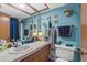 Well-lit bathroom with vintage decor, a white sink and toilet, and blue walls at 6813 Porcher Dr. # 25, Myrtle Beach, SC 29572
