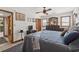Comfortable bedroom with ceiling fan, wood furniture and access to a dressing area at 6813 Porcher Dr. # 25, Myrtle Beach, SC 29572