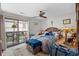 Bedroom with access to a screened porch, ceiling fan, and comfortable looking bed at 6813 Porcher Dr. # 25, Myrtle Beach, SC 29572