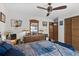 Cozy bedroom featuring a ceiling fan, wooden dresser with decor, and warm lighting at 6813 Porcher Dr. # 25, Myrtle Beach, SC 29572