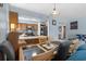 Open-concept dining area and kitchen with tile flooring and wood cabinets at 6813 Porcher Dr. # 25, Myrtle Beach, SC 29572