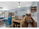Cozy dining room featuring a wood table, blue walls, and open shelving next to the living room at 6813 Porcher Dr. # 25, Myrtle Beach, SC 29572