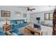 Inviting living room with a comfortable blue sofa, ceiling fan, and a light and airy aesthetic at 6813 Porcher Dr. # 25, Myrtle Beach, SC 29572