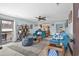 Inviting living room with blue sofas, ceiling fan, and a doorway to the balcony at 6813 Porcher Dr. # 25, Myrtle Beach, SC 29572