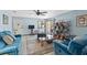 Open living room featuring tile floors, blue sofas, ceiling fan, and lots of light at 6813 Porcher Dr. # 25, Myrtle Beach, SC 29572