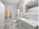 Modern bathroom with a gray vanity, white countertops, and coordinated towels, blending style and functionality at 6887 King Arthur Dr., Myrtle Beach, SC 29588