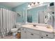 Stylish bathroom with a large mirror, blue accents, and a shower with a striped curtain at 6887 King Arthur Dr., Myrtle Beach, SC 29588