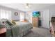 Tranquil bedroom with a ceiling fan, wooden dresser with TV, and neutral tones, offering a peaceful setting at 6887 King Arthur Dr., Myrtle Beach, SC 29588