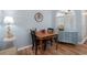 Cozy dining area with hardwood floors, shuttered windows, and space for a four-person table at 6887 King Arthur Dr., Myrtle Beach, SC 29588