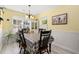 Charming dining area with a chandelier, table for six, and a hutch filled with decorative items at 6887 King Arthur Dr., Myrtle Beach, SC 29588