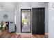 Inviting foyer featuring a patterned glass storm door, wood flooring, and calming light blue walls at 6887 King Arthur Dr., Myrtle Beach, SC 29588