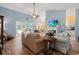 Inviting living room with hardwood floors, a fireplace, and open access to the kitchen and dining areas at 6887 King Arthur Dr., Myrtle Beach, SC 29588