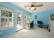 Bright office space with blue walls, a sewing station, and natural light, perfect for crafting and creativity at 6887 King Arthur Dr., Myrtle Beach, SC 29588